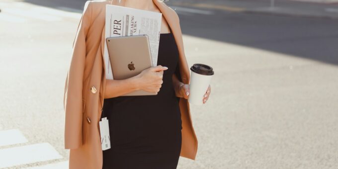 a woman in a black dress holding a cup of coffee