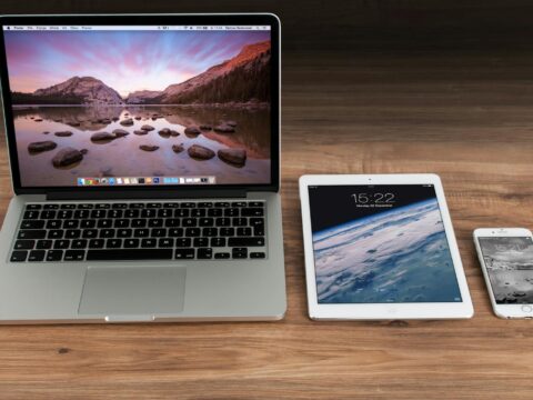 Macbook Pro Beside White Ipad